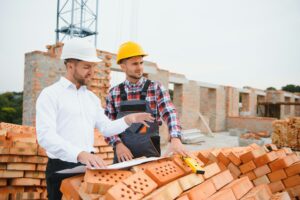 Construction engineers supervising progress of construction project